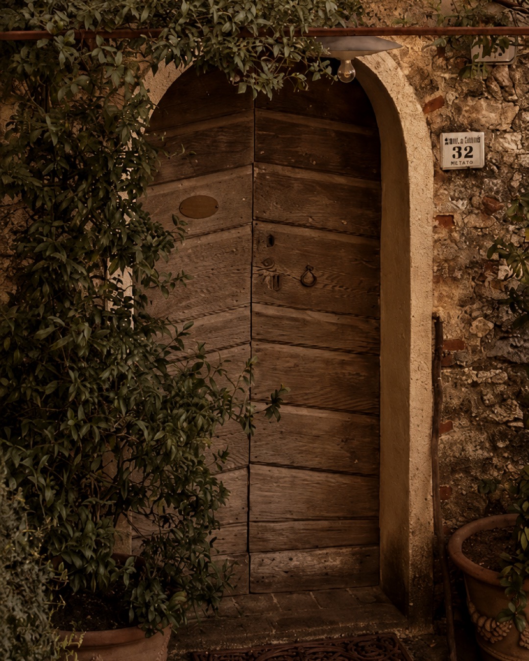 Restored interior with arched doorway and terracotta floor