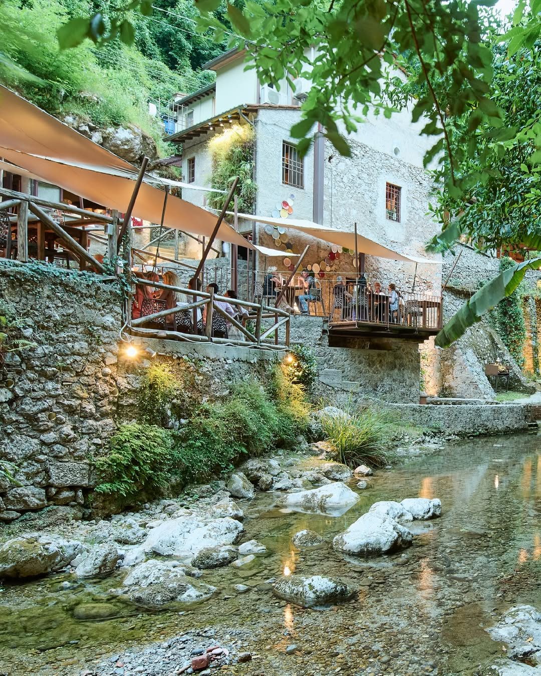 Tables beside the water at Osteria Candalla near Camaiore.