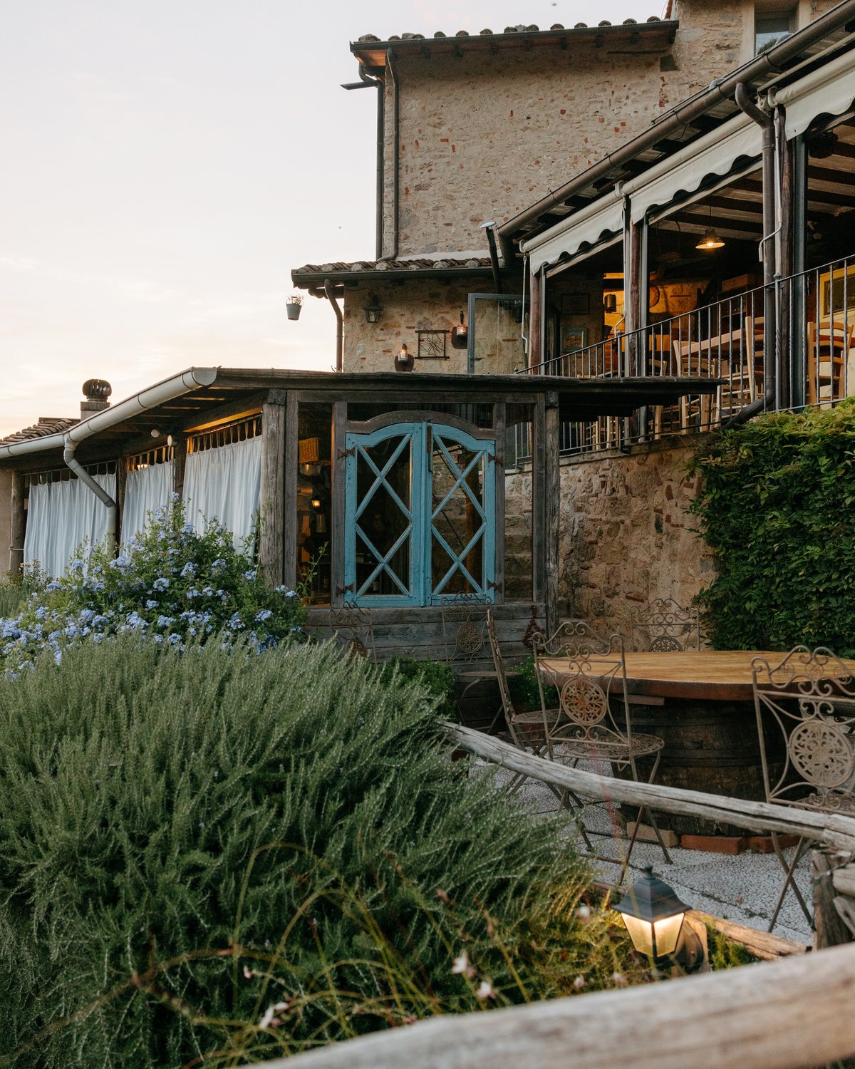 The stone house and garden terrace of Il Fondaccio in the hills above Camaiore.